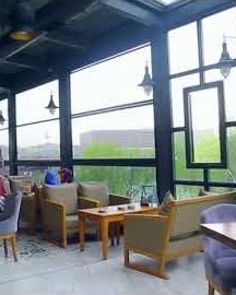 Restaurant patio with louvered pergola and guillotine glass