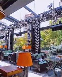 Restaurant with retractable roof pergola and guillotine glass