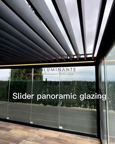 Wall-mounted louvered pergola with zip screens and glass on three sides